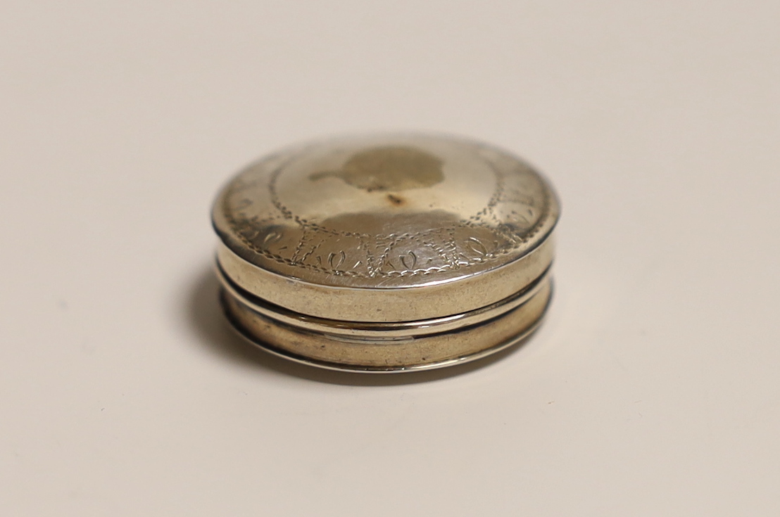 An early 19th century white metal counter box, 25mm, containing four counter numbered 1 to 4.